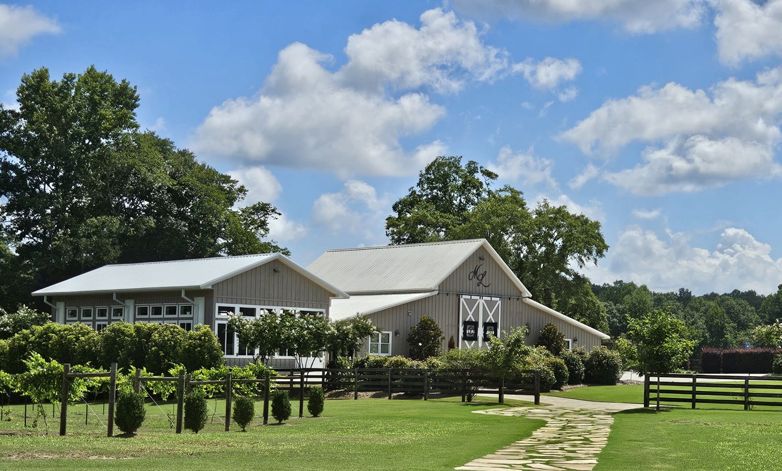 wedding venue with blue sky, green grass as seen from a vineyard