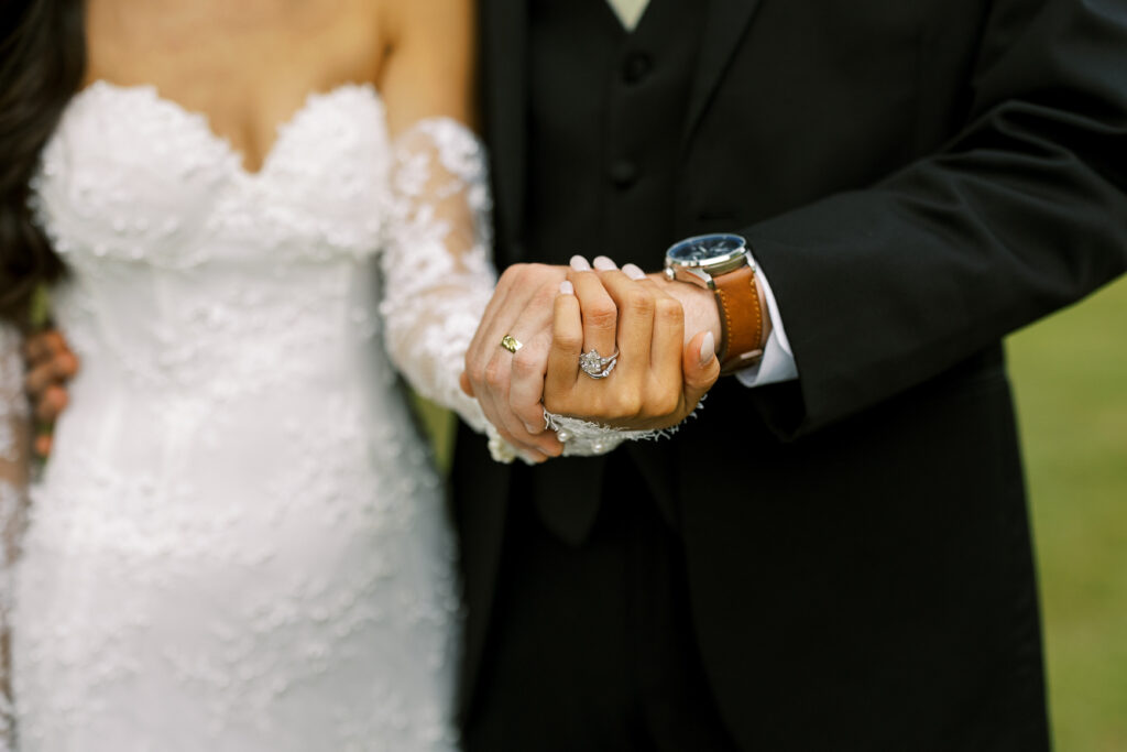 Newly married bride and groom holding hands at a wedding venue located near Atlanta