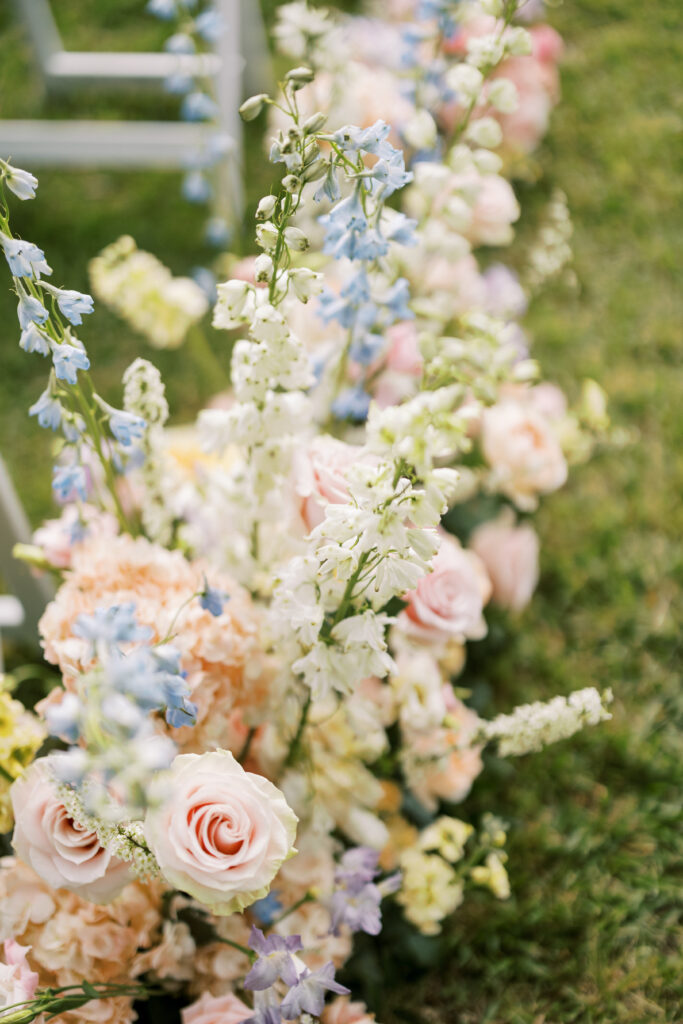 Beautiful aisle spring flowers from a florist for an outdoor wedding ceremony at a wedding venue in Newnan, GA