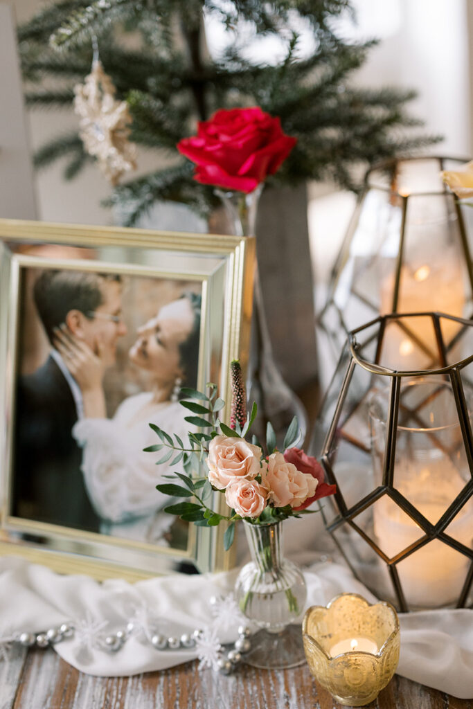 December welcome table with engagement photos, candlelight and florals at the wedding reception at a  wedding venue near Atlanta