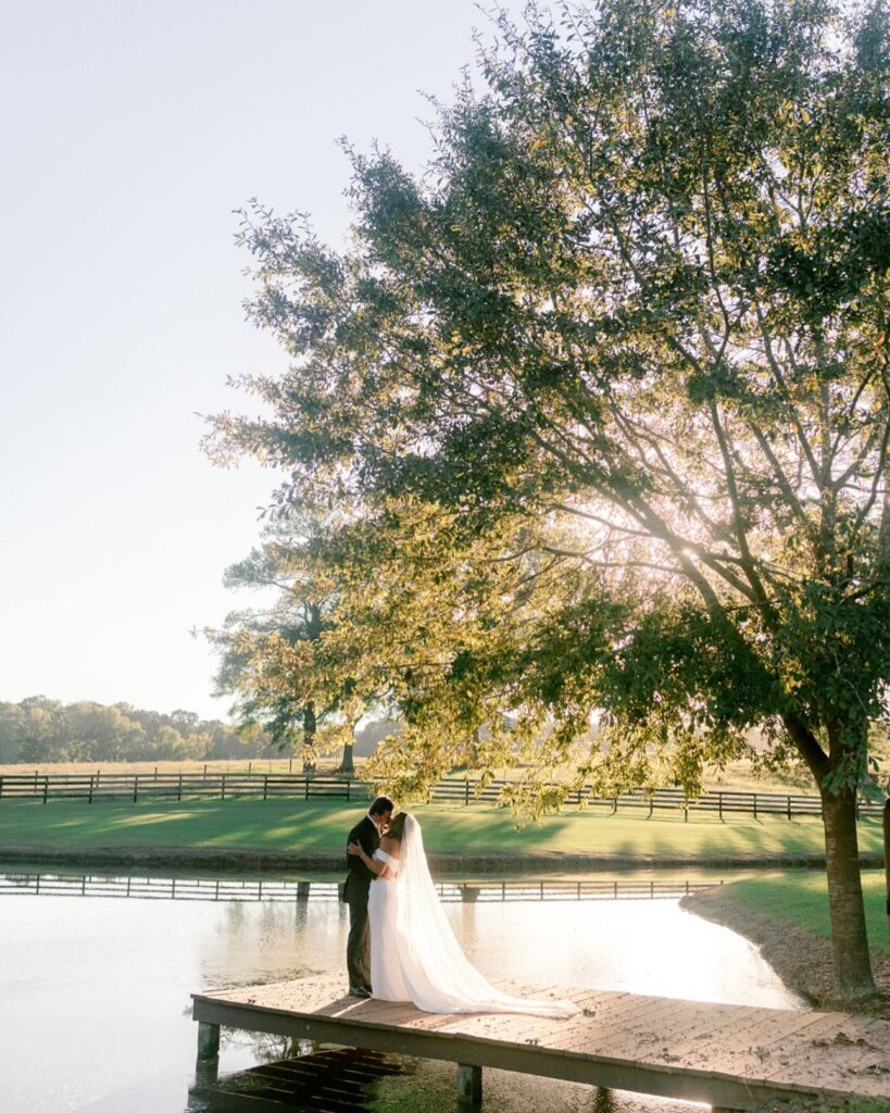 Golden hour photos with the bride and groom at a pond on  The Venue at Murphy Lane property located one hour from Atlanta 