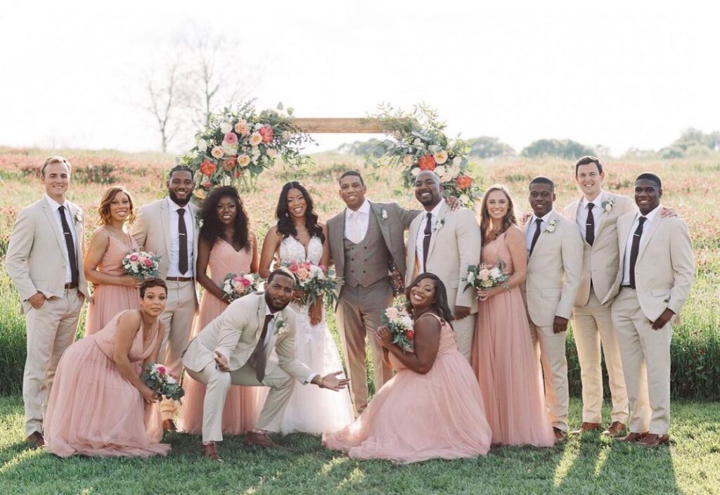 Spring wedding with the bridal party and bride and groom at an outdoor ceremony site in the field at a wedding venue near Atlanta, Georgia