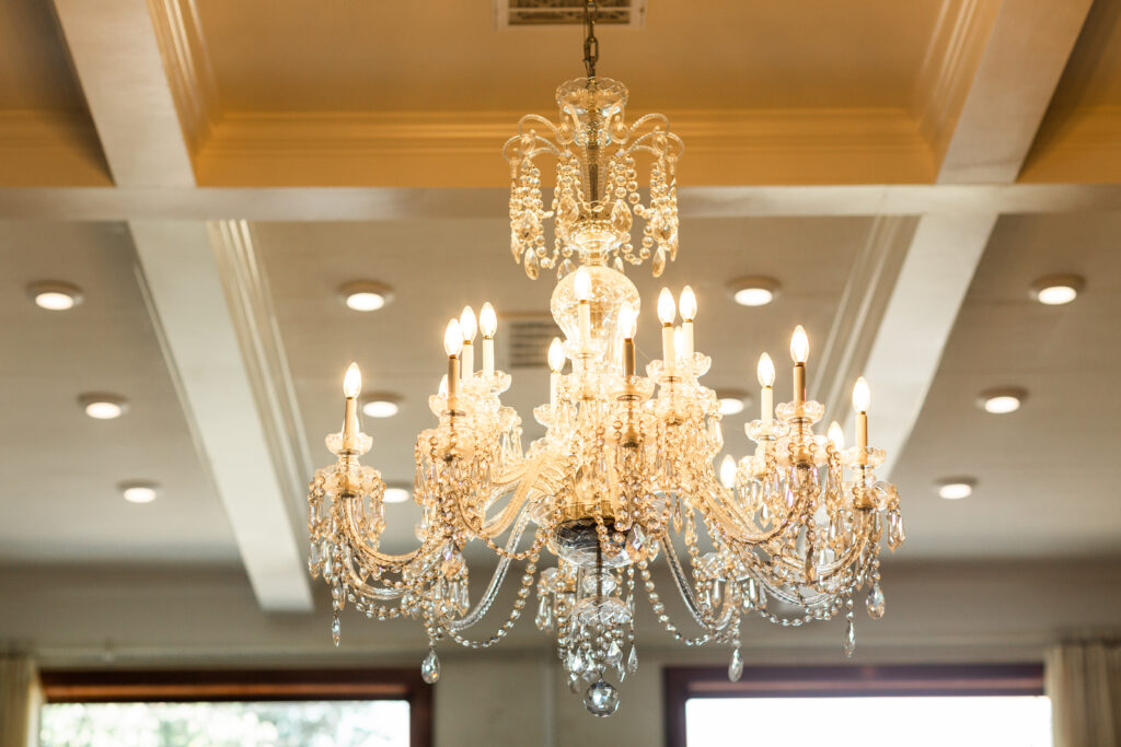 Grand crystal chandelier located inside the modern barn venue at a wedding located in Newnan, GA which is about an hour away from Atlanta